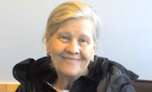 Diane smiling to the camera before dementia overcame her