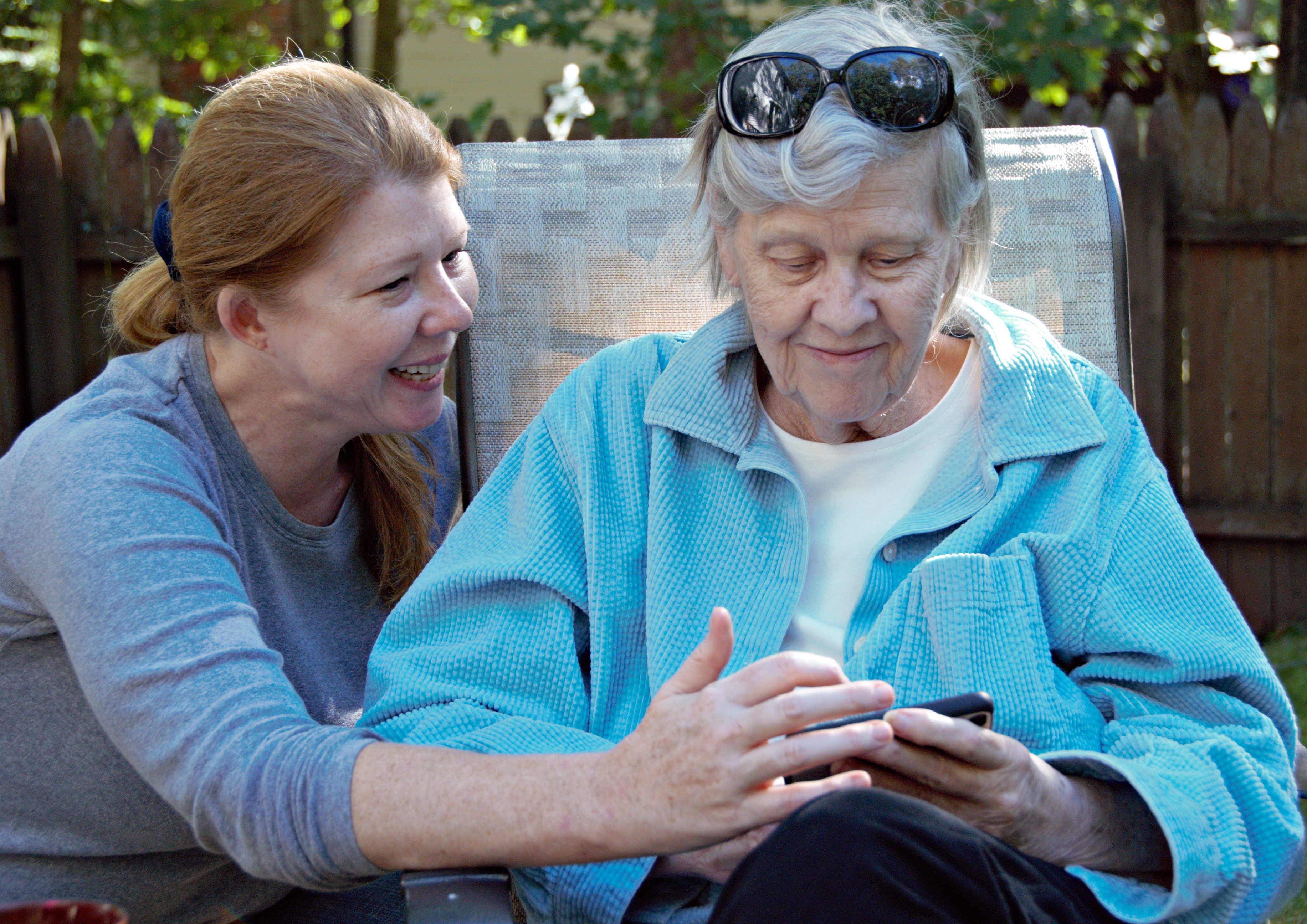 Jennifer and Diane seated, viewing something together