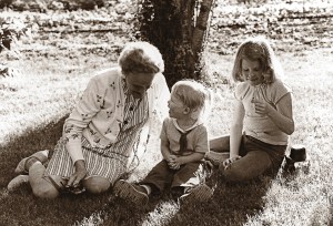 Diane's 82-year-old grandmother sits with Lauren and Jennifer on the grass beneath a tree